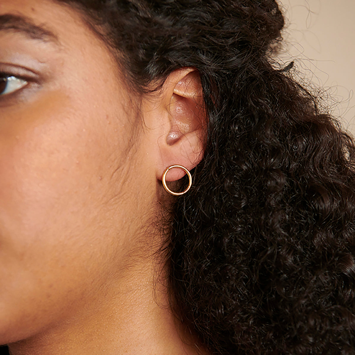 A model wears the single hoop from the Double Hoop Posts.