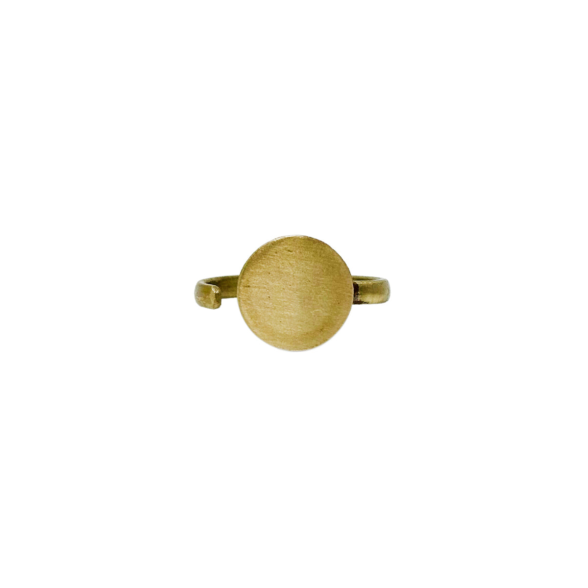 A gold ring with a large circle center motif is shown against a white background.
