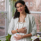 Model wearing the colorful  Kantha Capri Collection featuring groups of colorized Kantha beads separated by smaller metallic beads.