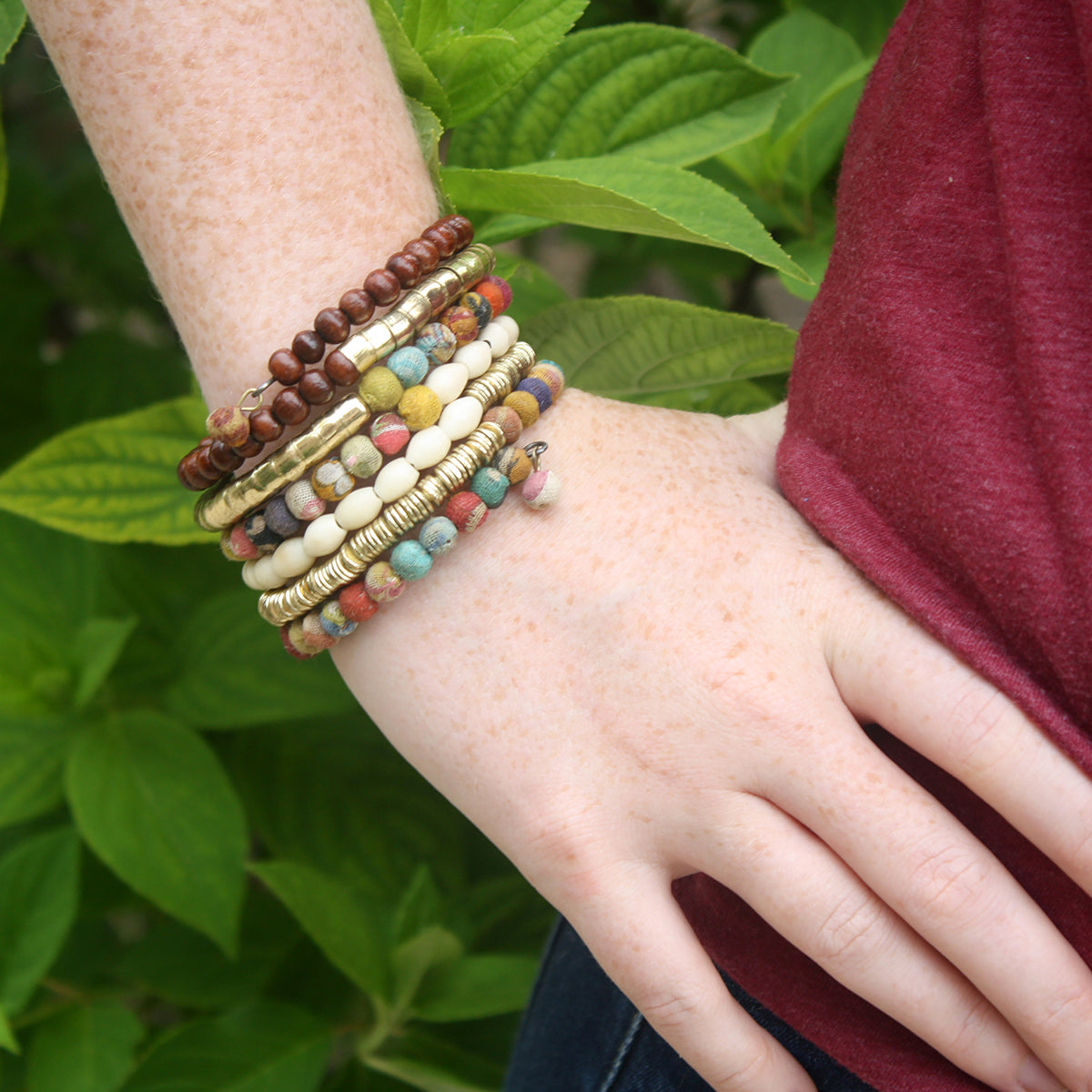 A close up of a models wrist and her multibead bracelet.