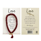 The front and back of a carded beaded bracelet against a white background.