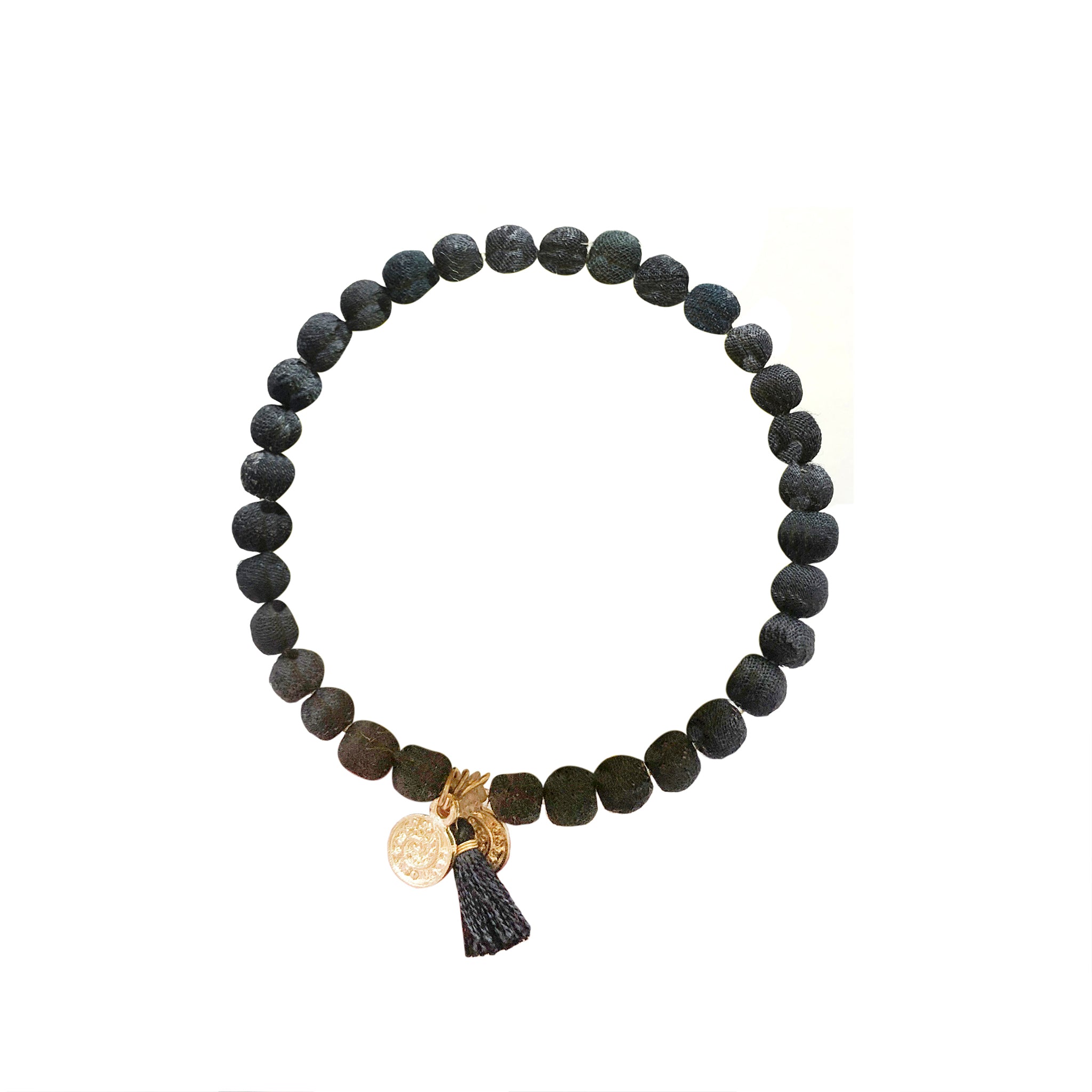 A black beaded bracelet is accented with a black tassel and two charms