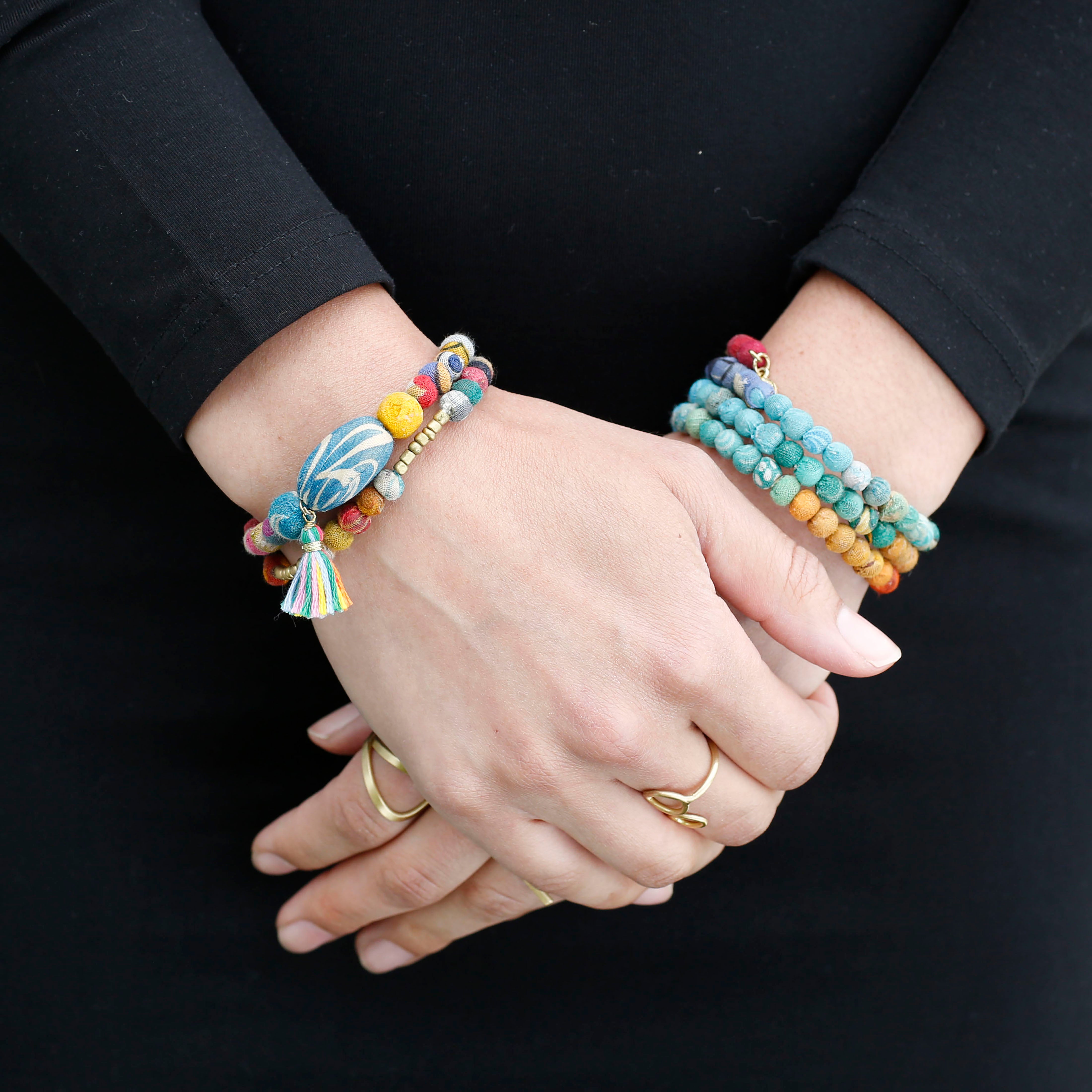 Kantha Rainbow Spiral Bracelet is seen on a model.