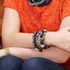 The Kantha Indigo Wrap Bracelet adorns a woman's arm.