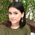 A woman wears the Kantha Cleo Necklace.