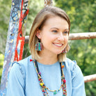 A woman models the Fringed Kantha Earrings.