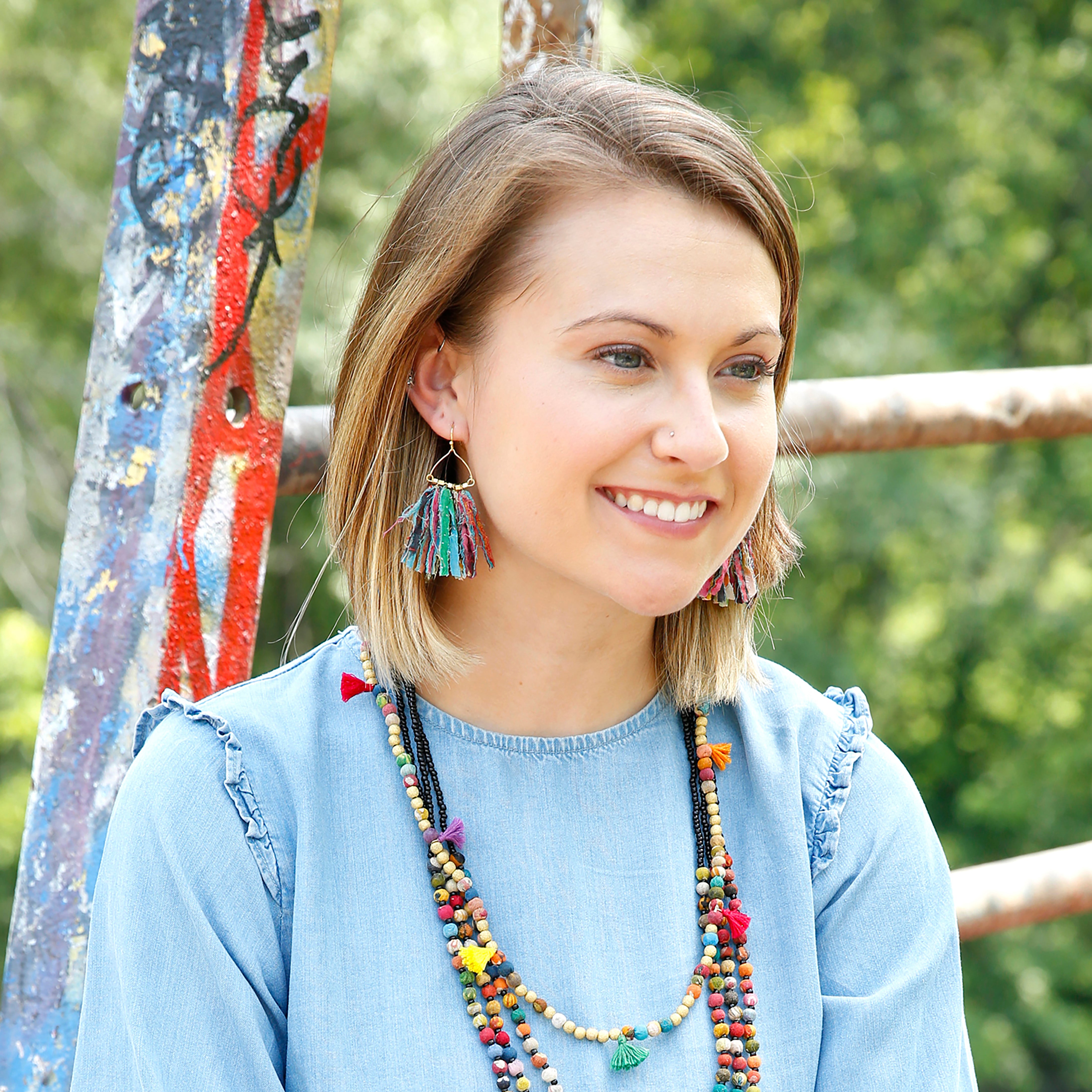 A woman models the Fringed Kantha Earrings.