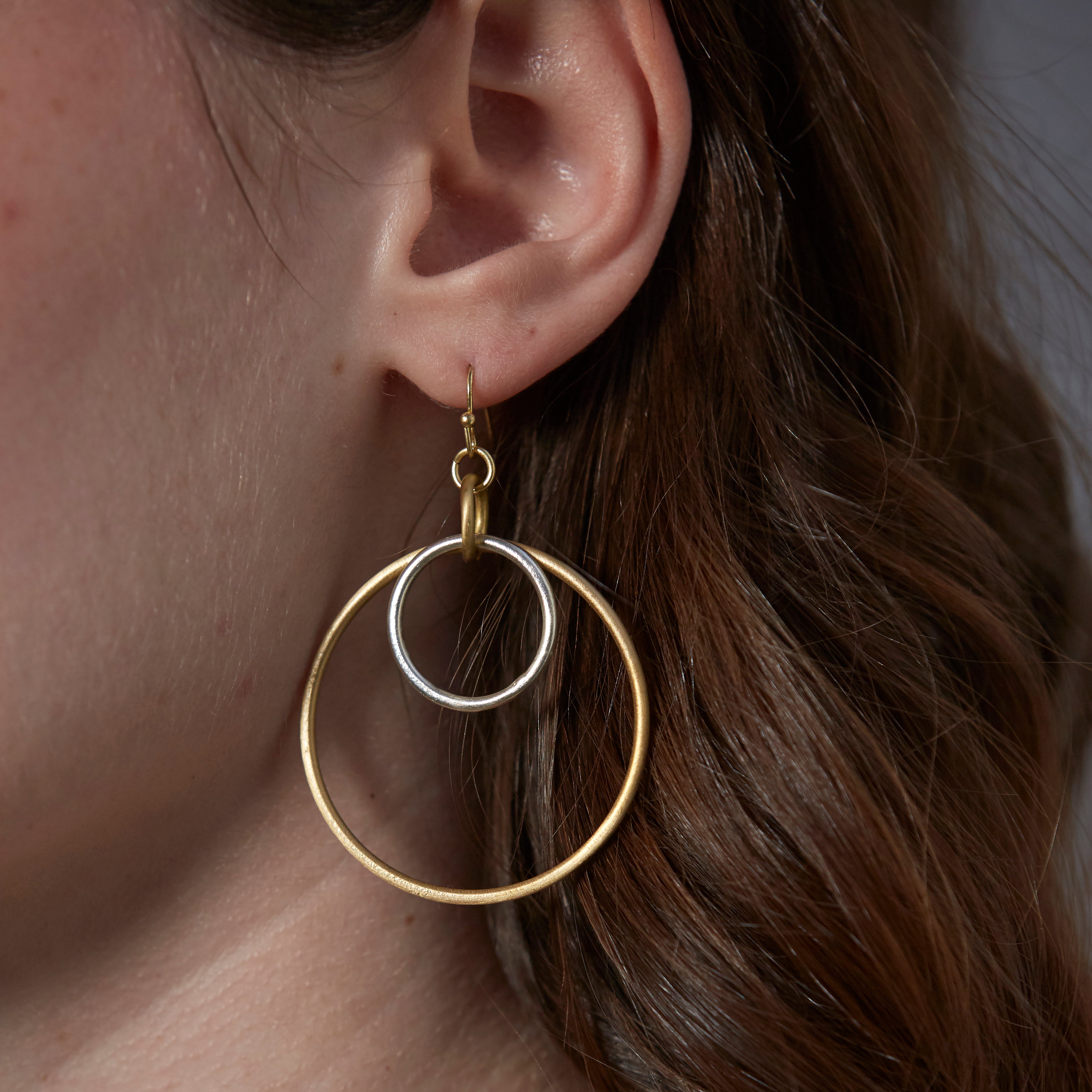 A model wears the Borealis Hoop Earrings.