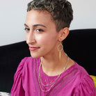 A woman models the Elongated Leaf Hoop Earrings.