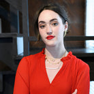 A woman wears the Charmed Necklace along with other fair trade jewelry.