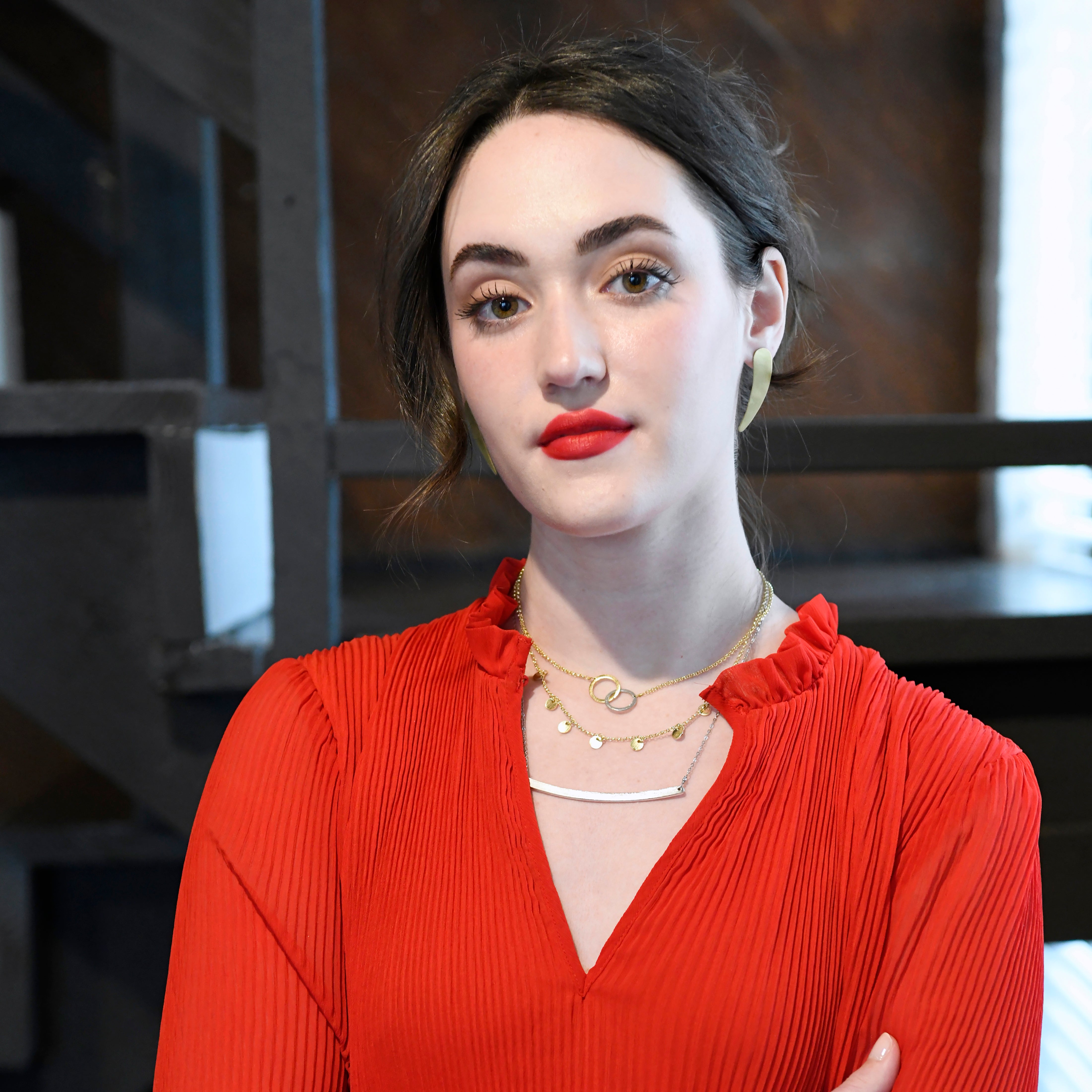 A woman wears the Charmed Necklace along with other fair trade jewelry.