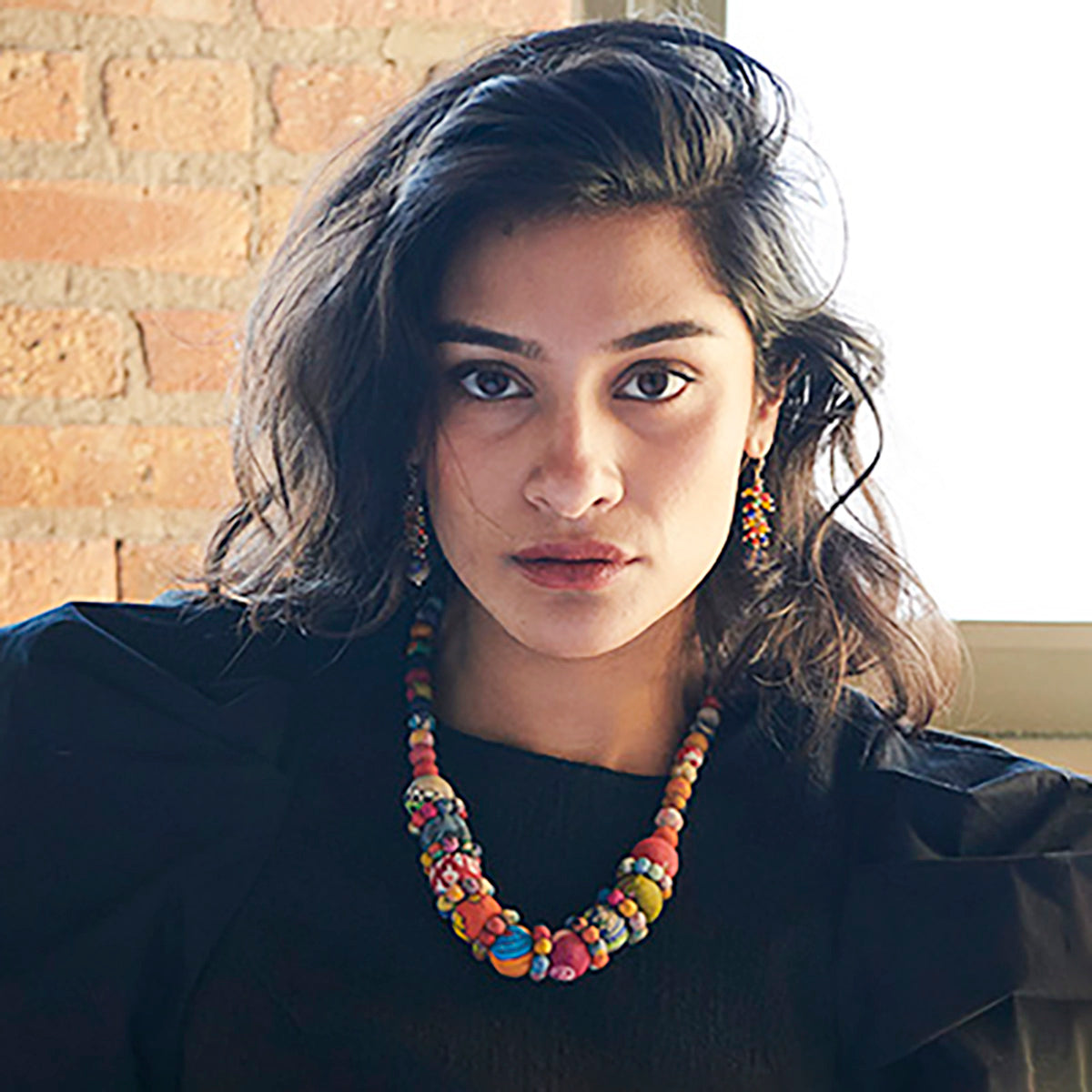 A model wears the Kantha Orbit Necklace.