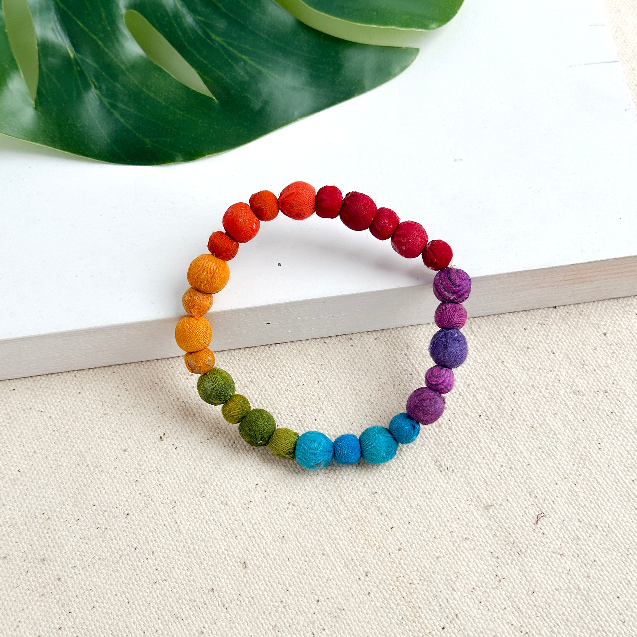 Kantha Prism Poetic Bracelet made of beads that have been sorted and arranged into vibrant, color-blocked sections for an multichromatic rainbow-like display of color.
