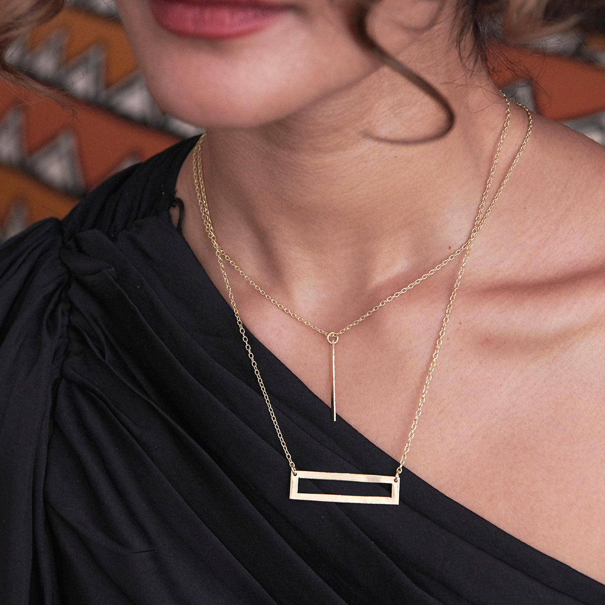 A model wears the Cutout Rectangle Pendant Necklace.