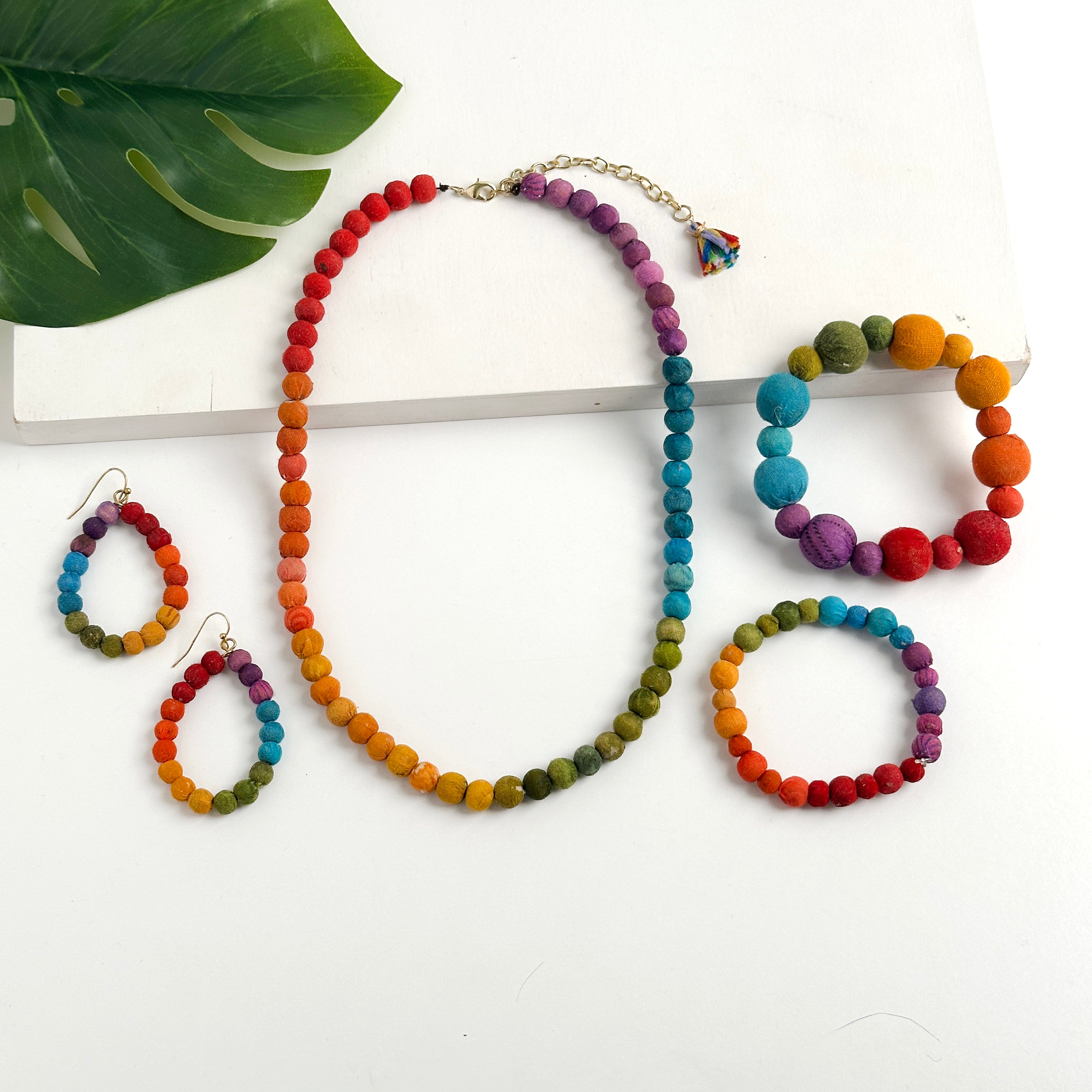 Kantha Prism Collection made of beads that have been sorted and arranged into vibrant, color-blocked sections for an multichromatic rainbow-like display of color.
