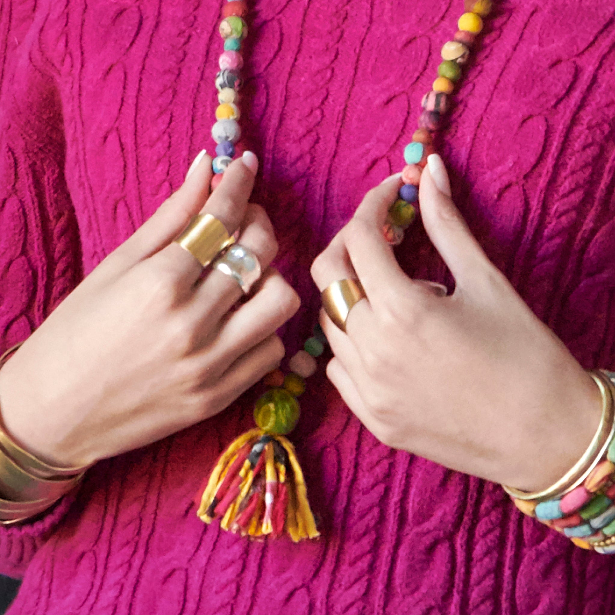 A woman's hands are shown adorned with various rings.
