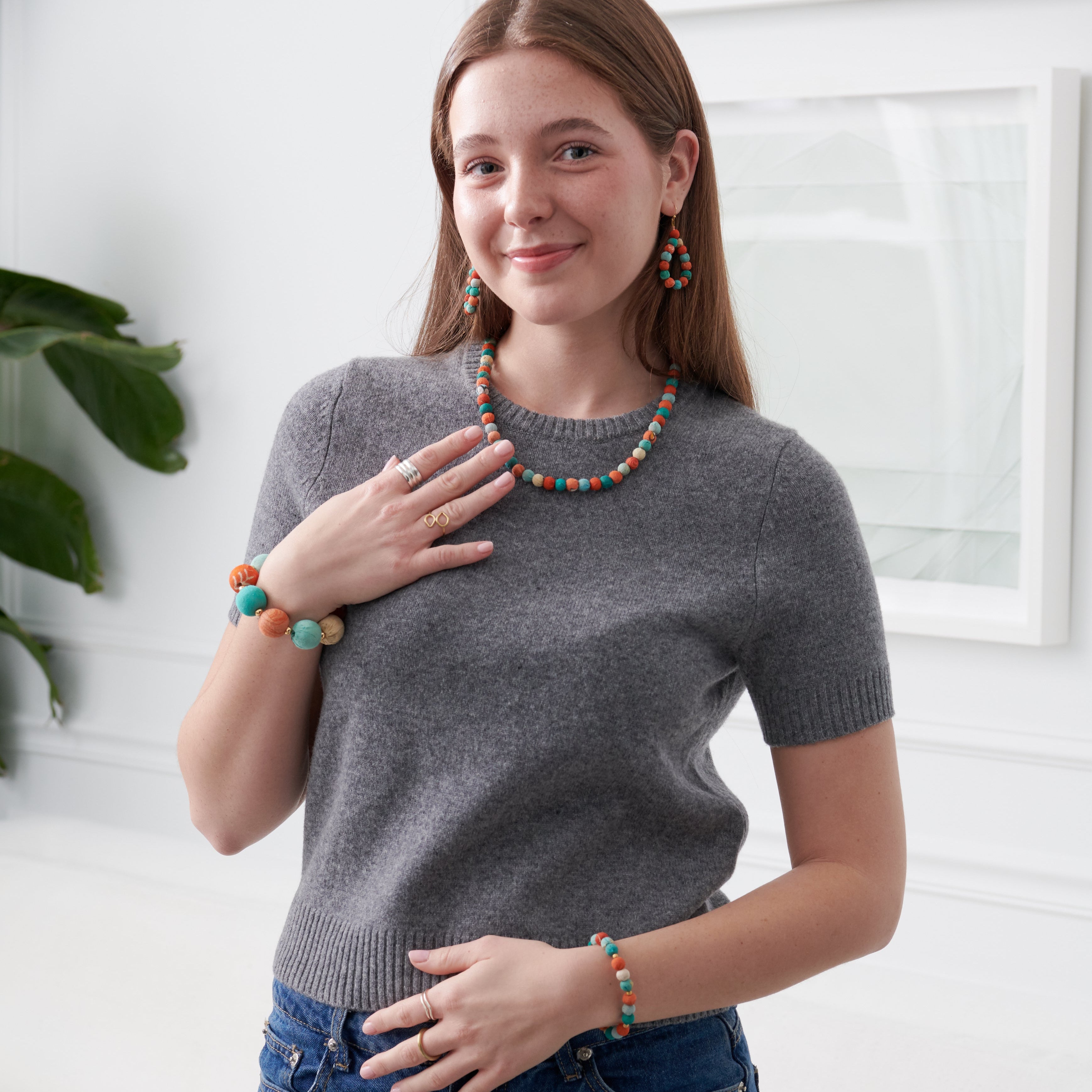 Model wearing the colorful  Kantha Capri Collection featuring groups of colorized Kantha beads separated by smaller metallic beads.
