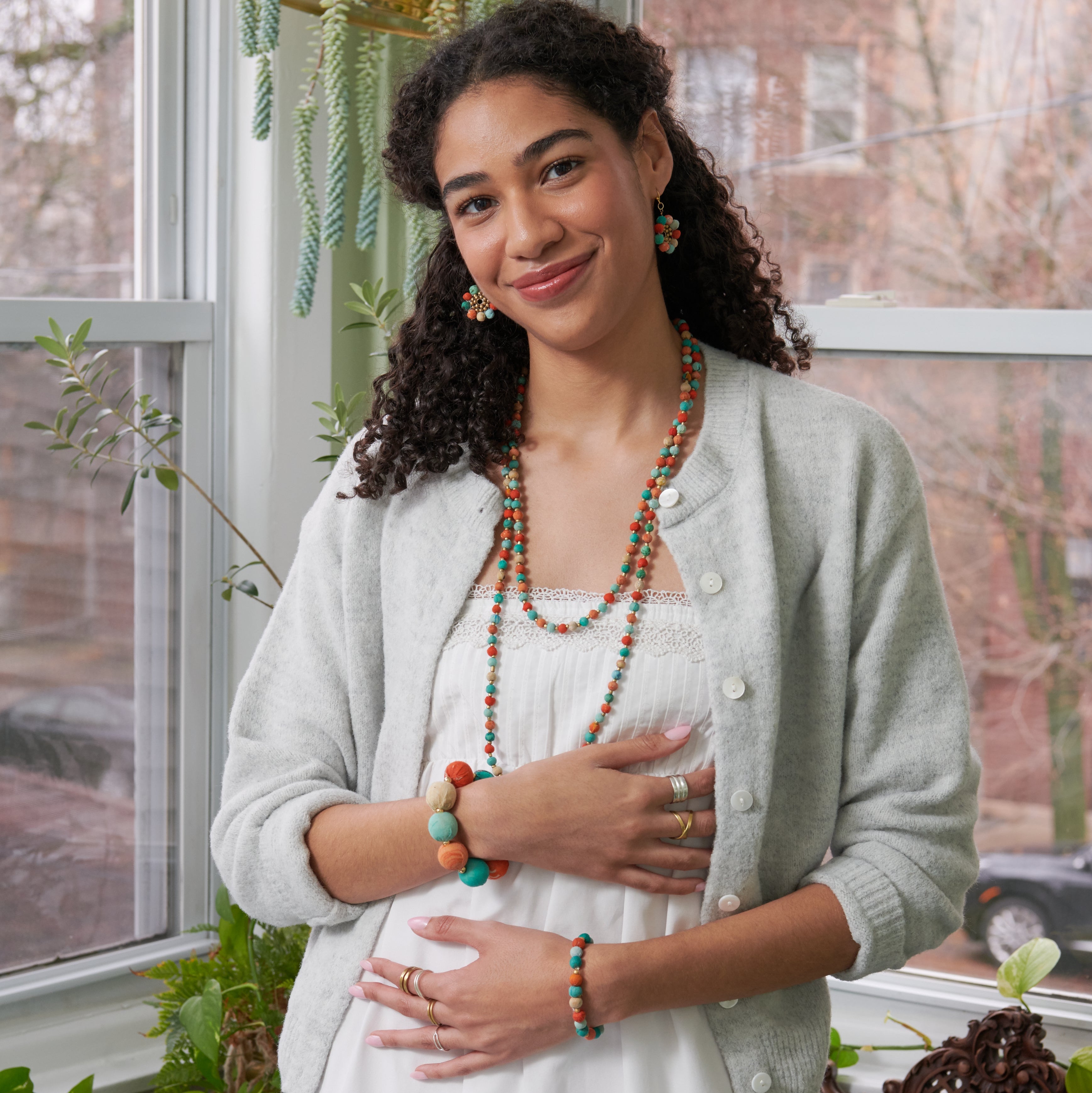 Model wearing the colorful  Kantha Capri Collection featuring groups of colorized Kantha beads separated by smaller metallic beads.