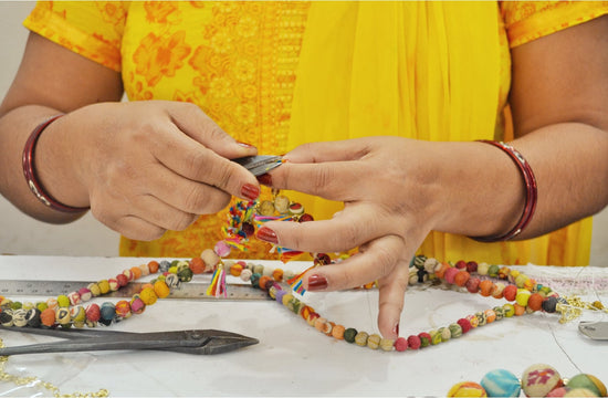 Woman crafting a necklace with tools