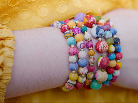 A woman's arm with colorful bracelets