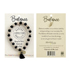 The front and back of a carded black and white bracelet against a white background.