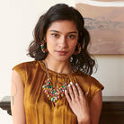 A woman wears the Confetti Kantha Hoops and statement necklace..
