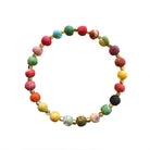 A bracelet made from small colorful textile-wrapped beads is shown against a white background