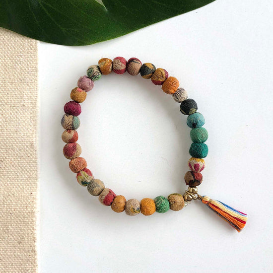 A single multicolor beaded bracelet is adorned with a multicolored tassel.