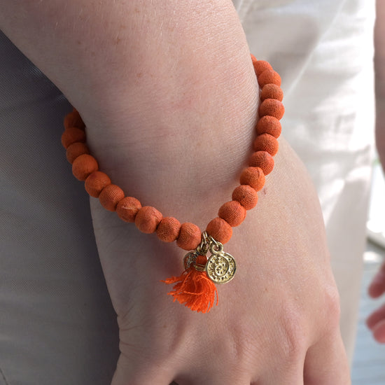 A Joy Kantha Connection Bracelet adorns a wrist.