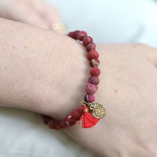 A Energy Kantha Connection Bracelet adorns a wrist.