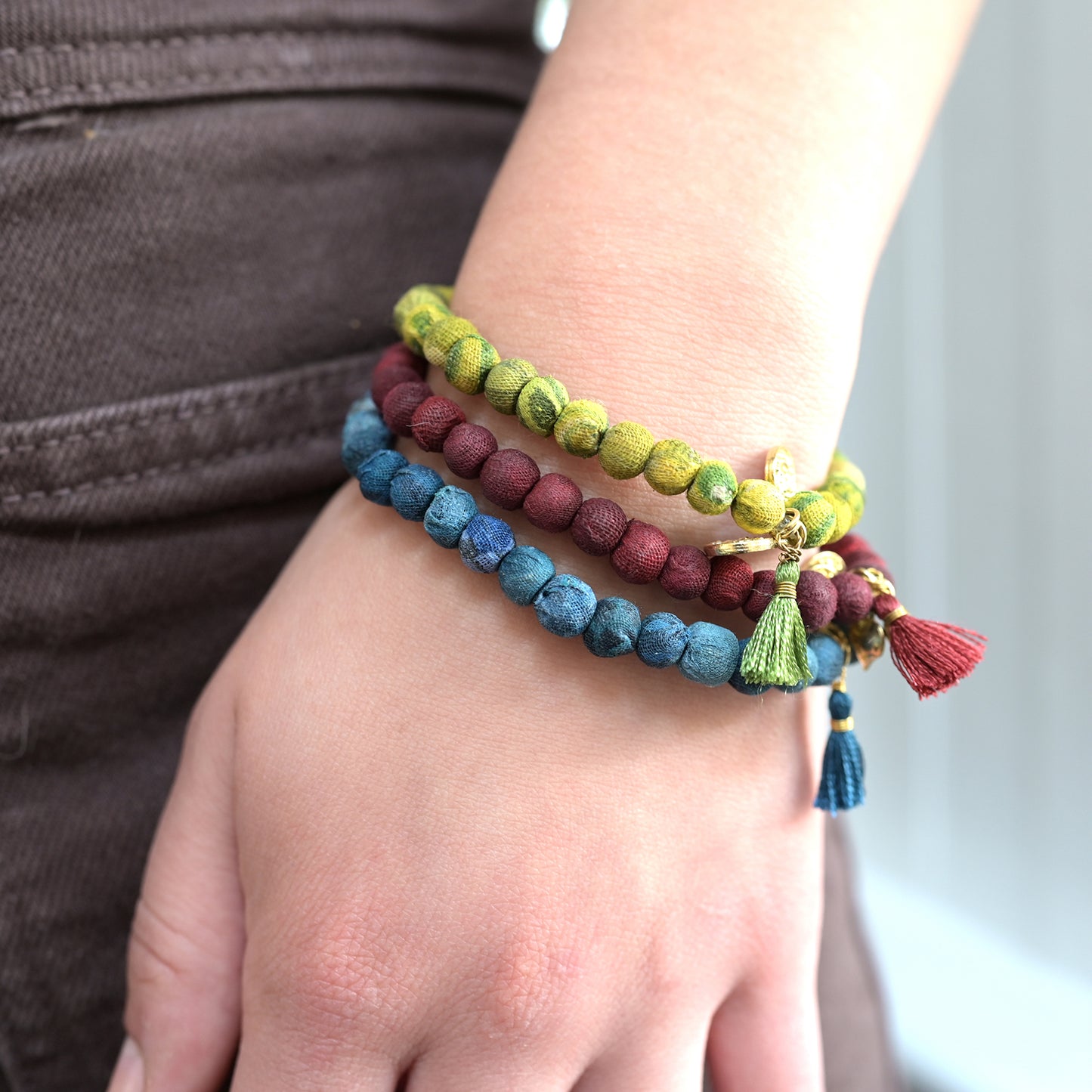 Load image into Gallery viewer, A model wears a stack of three Kantha Connection Bracelets
