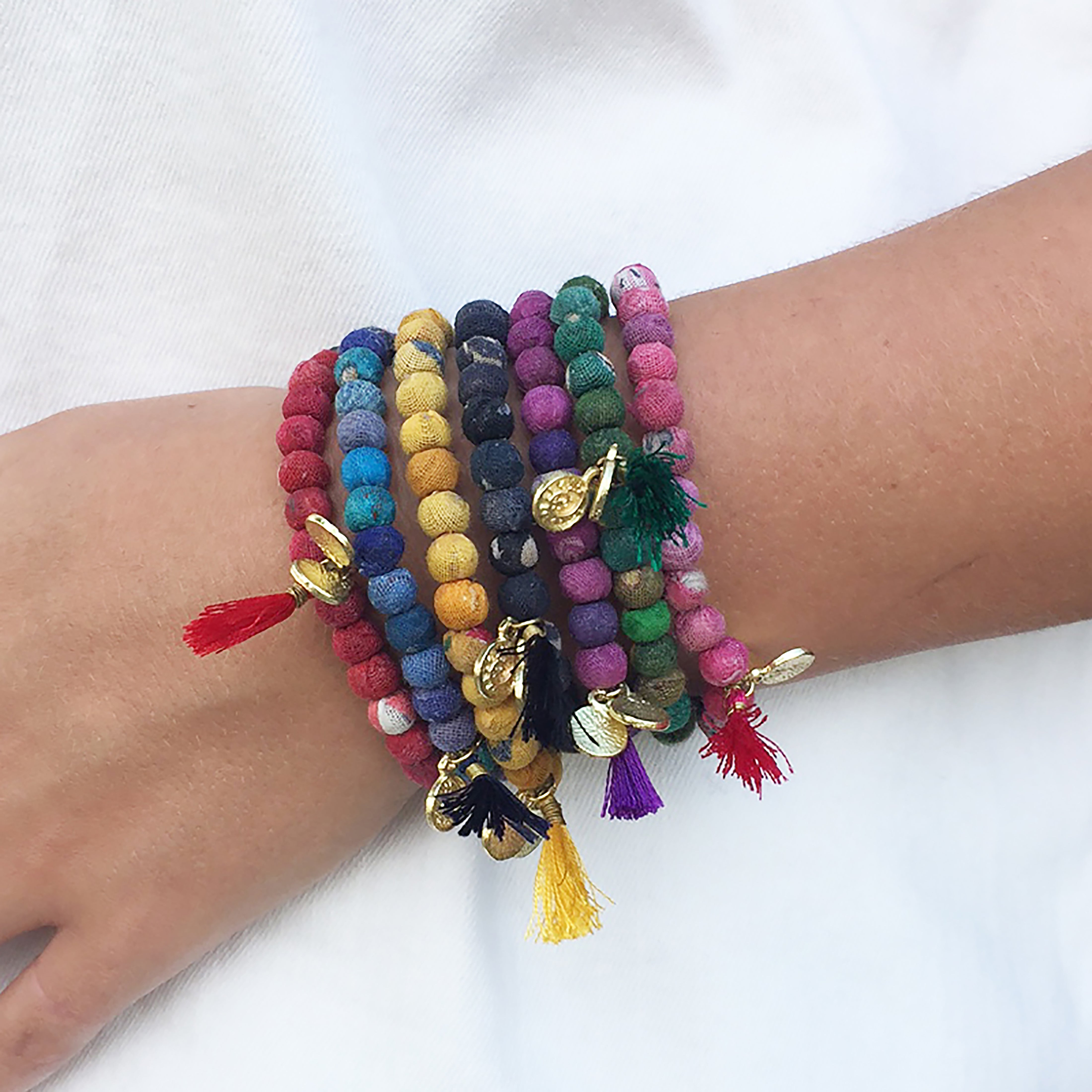 Multiple Kantha Connection bracelets adorn a wrist.