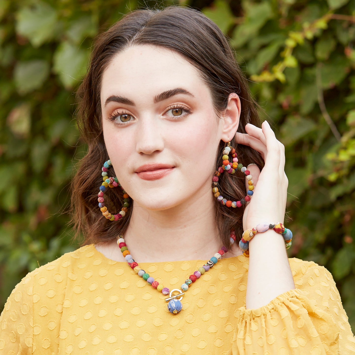 Load image into Gallery viewer, A model wears Dotted Oval Kantha Bracelet.
