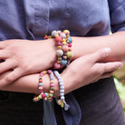 A woman models the Interlocking Kantha Toggle Bracelet.