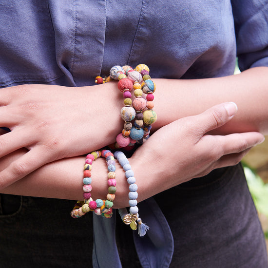 Load image into Gallery viewer, A woman models the Interlocking Kantha Toggle Bracelet.
