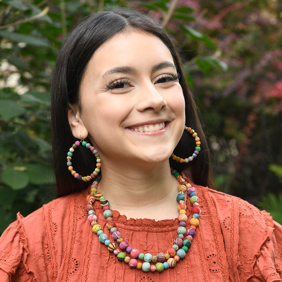 A model wears the Kantha Tandem Necklace along with other handmade jewelry.