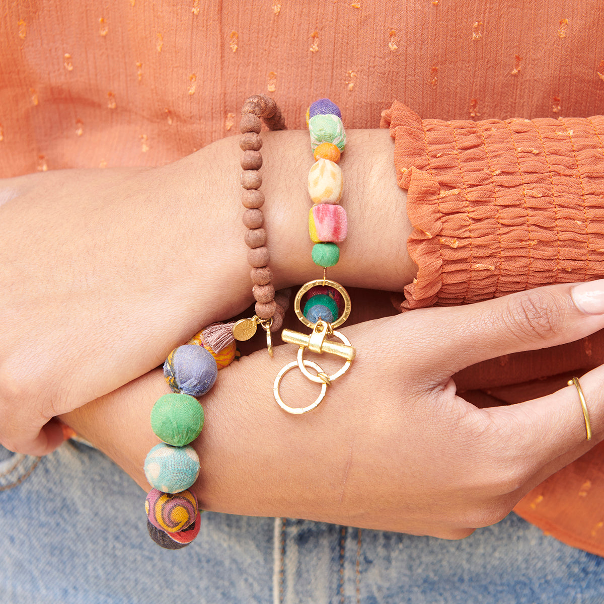 A wrist is adorned with the Kantha Contrary Bracelet.