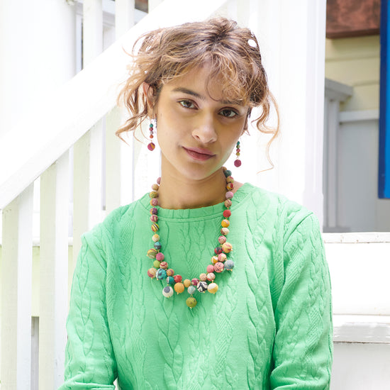 A woman wears the Kantha Bloom Necklace.