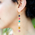 A woman wears the Kantha Raindrop Earrings.