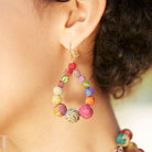 Kantha Graduated Teardrops adorn an ear.