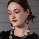 A woman models the Kantha Indigo Dangling Hoops.