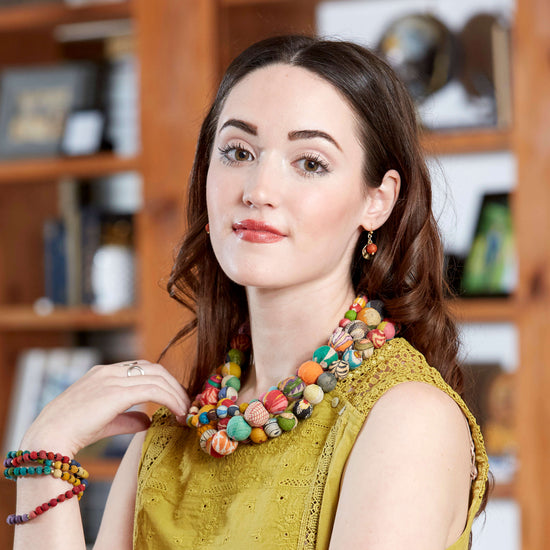 A woman models the Kantha Camille Earrings and Kantha Calypso Necklace.