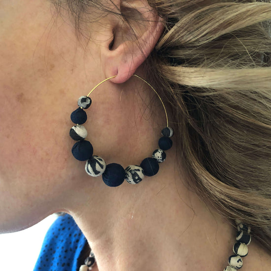 Load image into Gallery viewer, A woman wears the Kantha Indigo Graduated Hoops.
