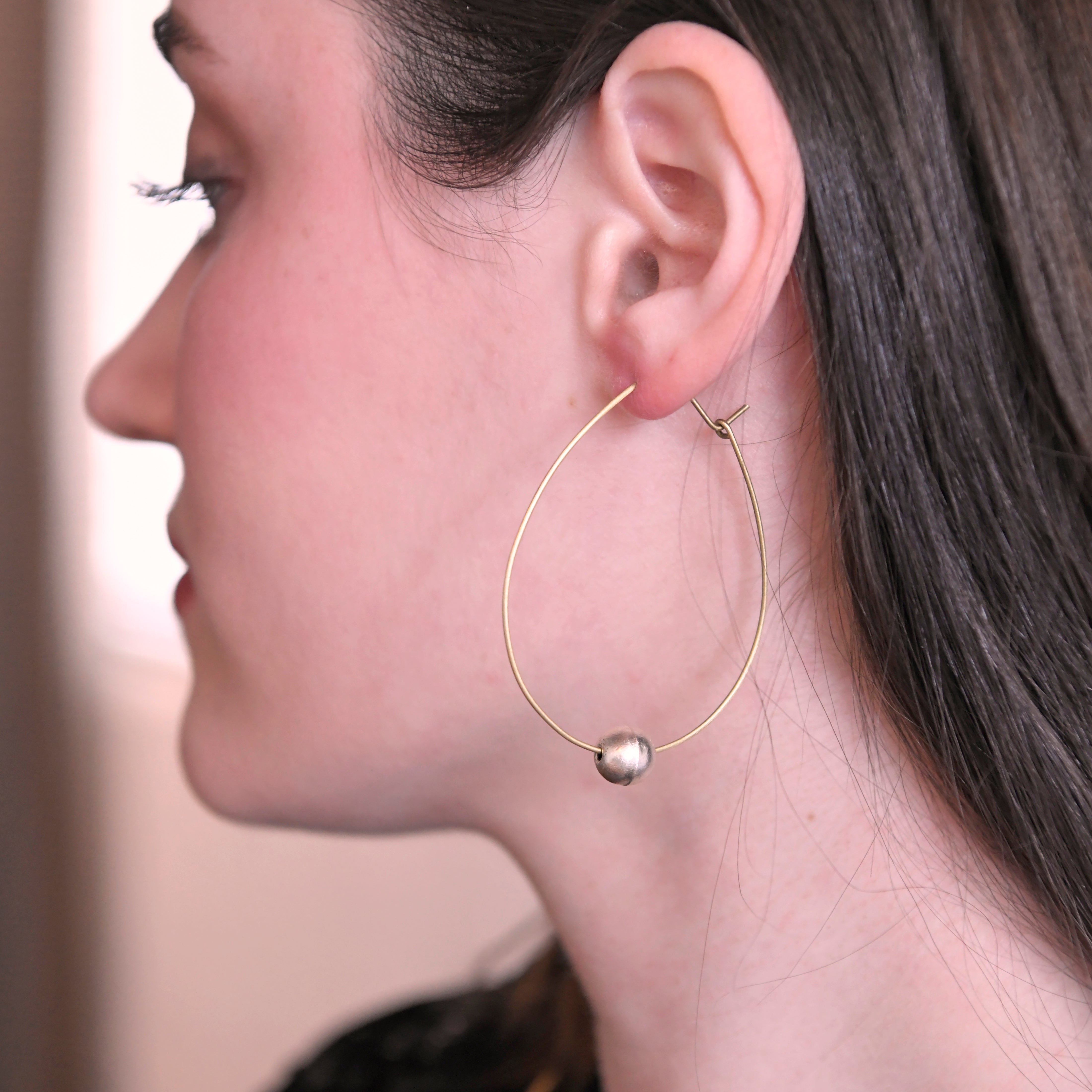 A woman models the Ethereal Bead Hoops.