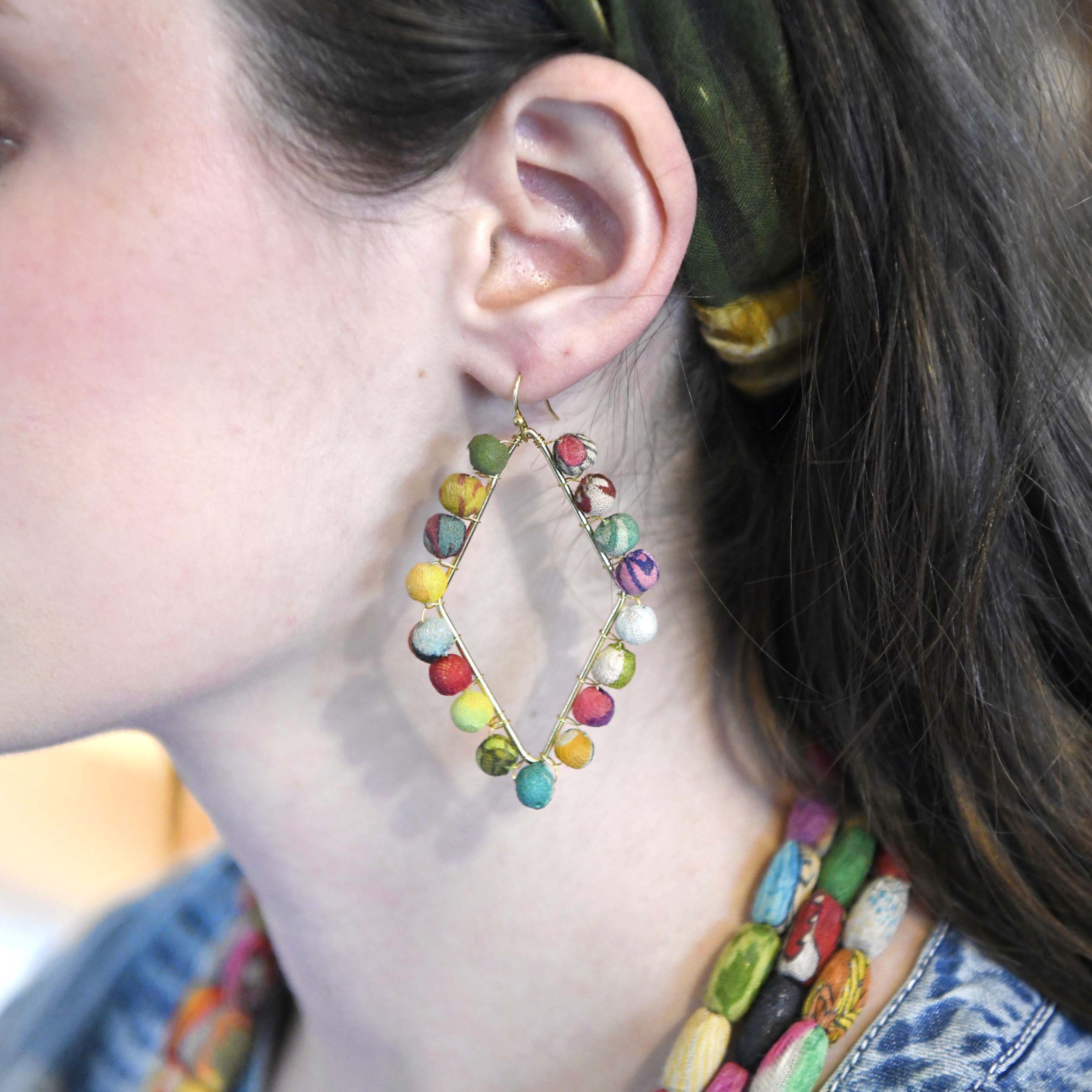 A model wears the Dotted Diamond Frame Earrings.