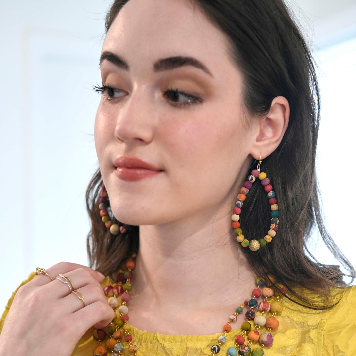 Load image into Gallery viewer, A woman models the Kantha Luna Drop Hoops.
