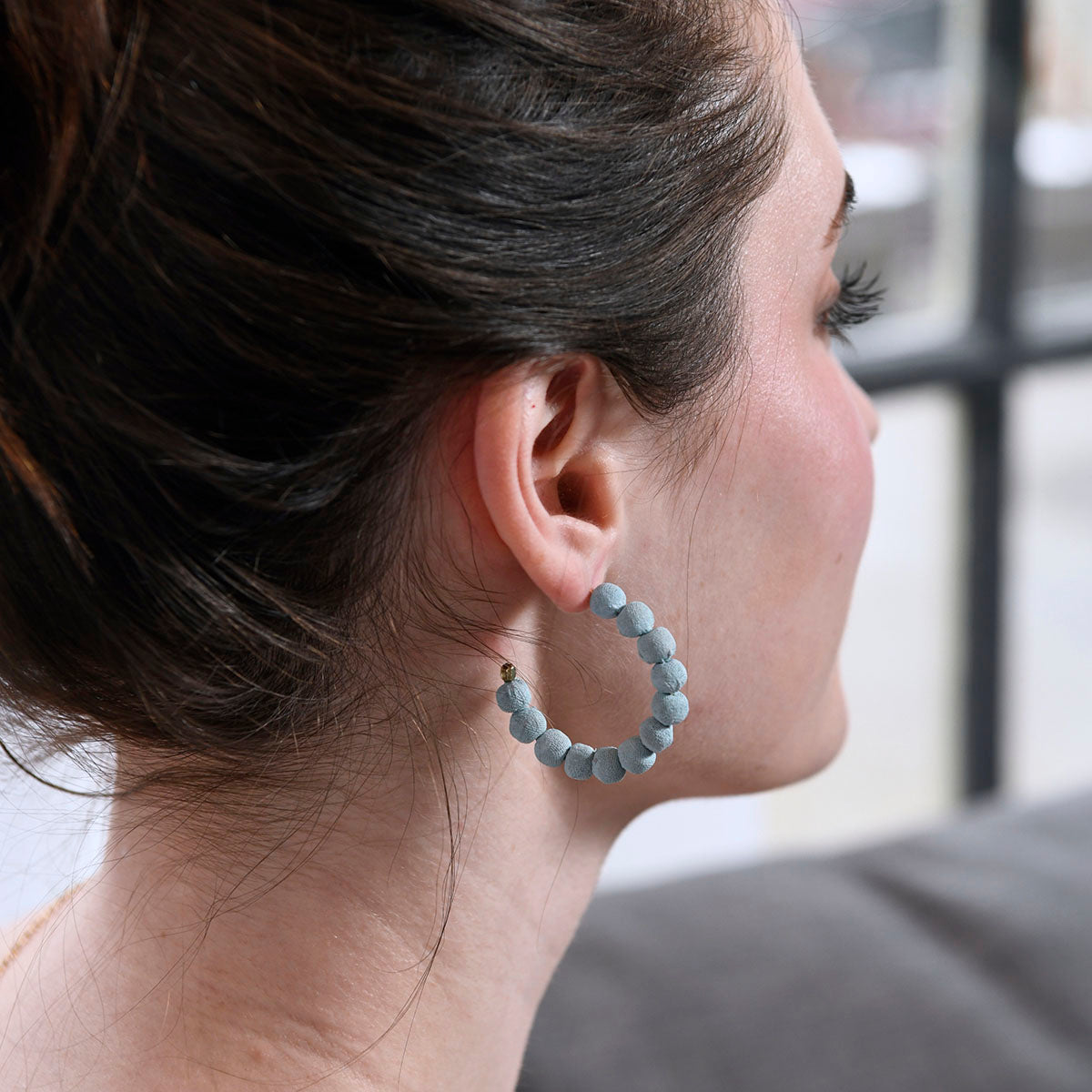 A woman models the Blue Skies Mini Hoops.