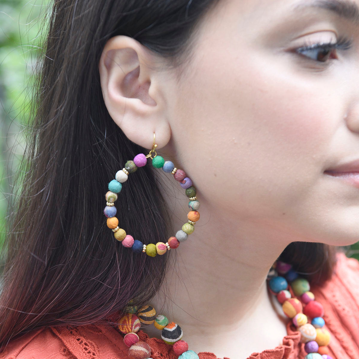 A woman models the Adorned Kantha Hoops.