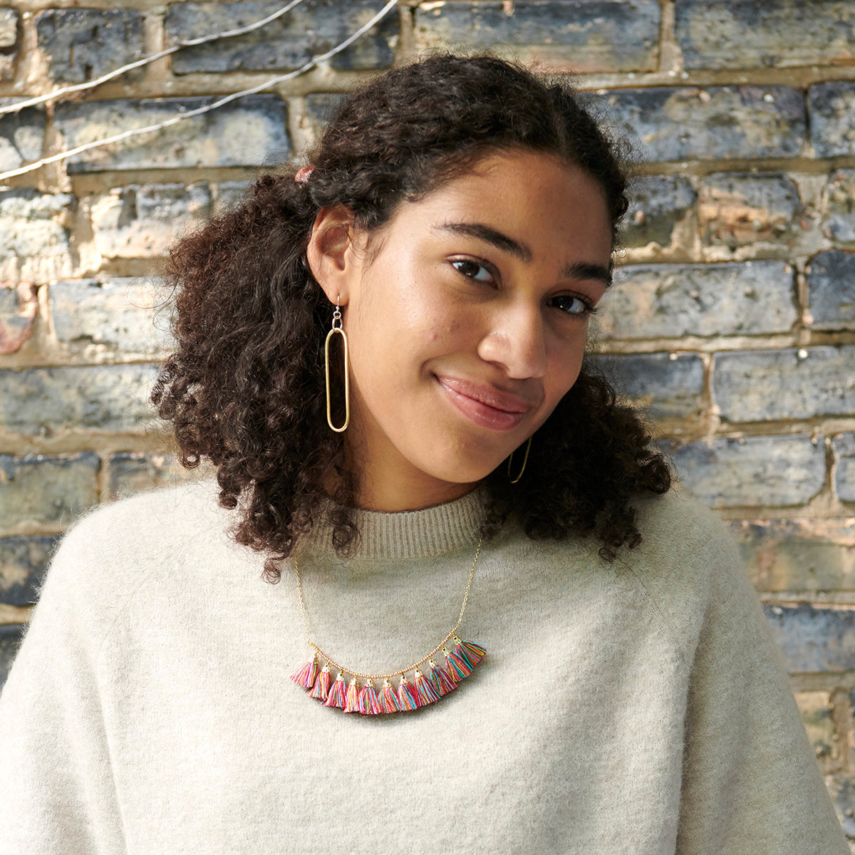 A woman models the Esme Earrings.