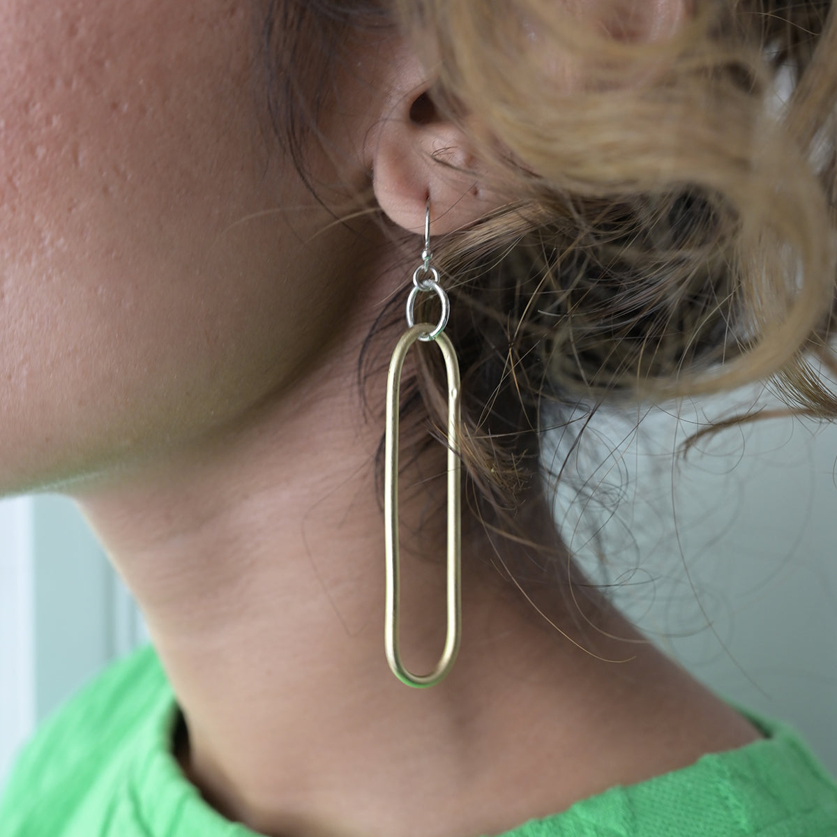 A woman models the Esme Earrings.